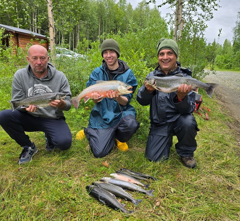 a group of people holding fish on a field