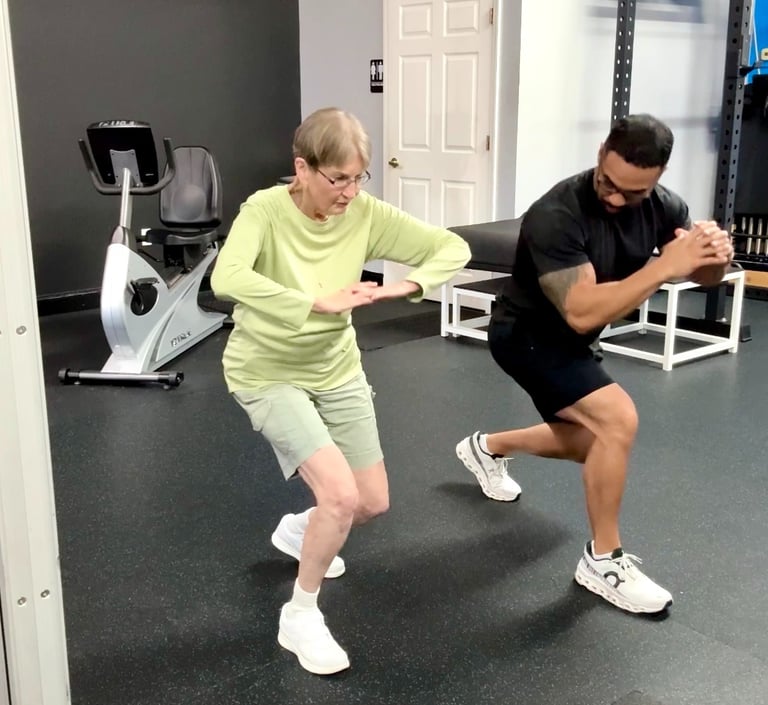 fitness trainer with elderly woman exercising