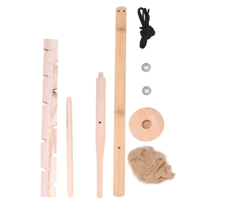 Bow drill fire starter kit with spindle, bow, fireboard, and tinder.