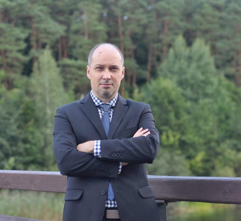 a man in a suit and tie standing on a bridge