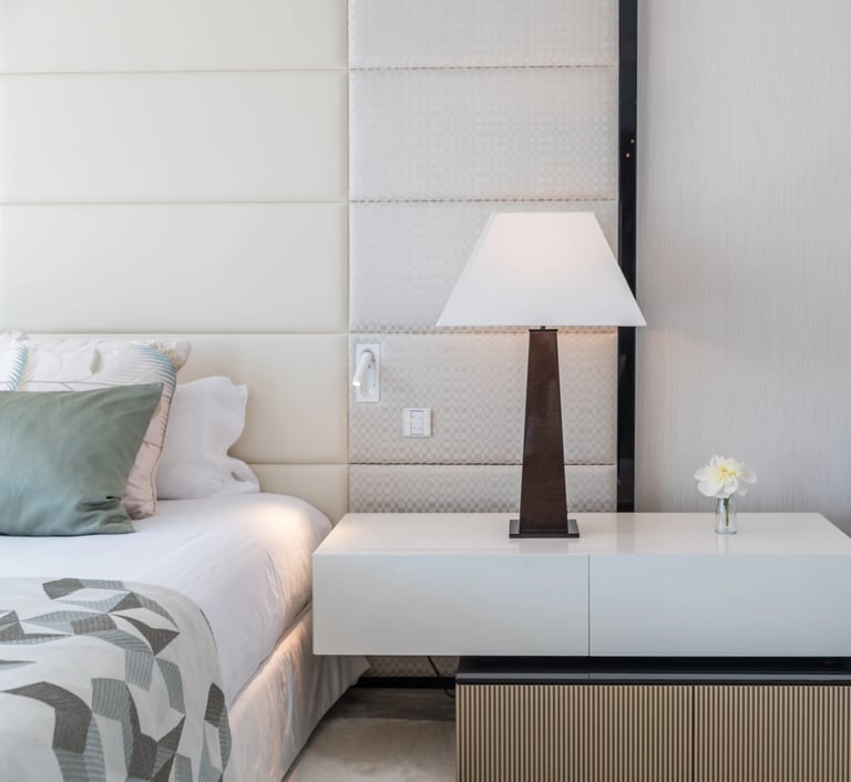 Modern luxury bedroom detail with lamp, sculpture, and soft tones at Villa Serenity