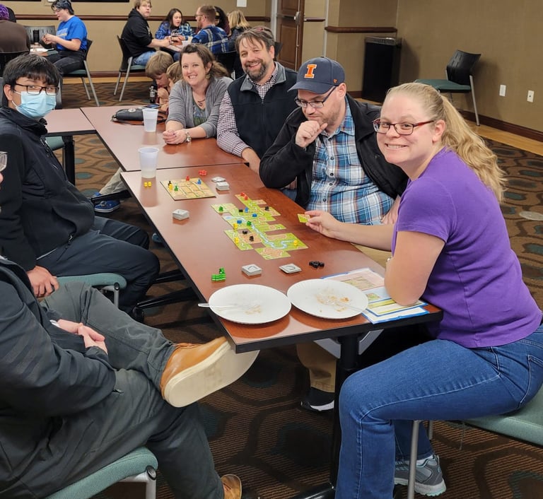 Dr. Hooton, history faculty, and students playing board games.