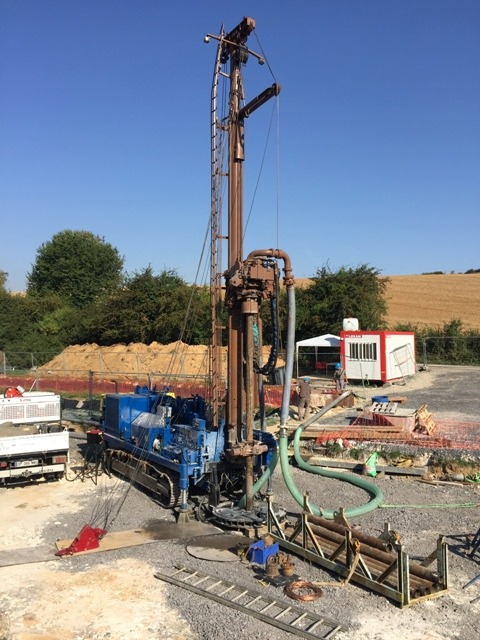 a drilling rig with a drilling machine in the background