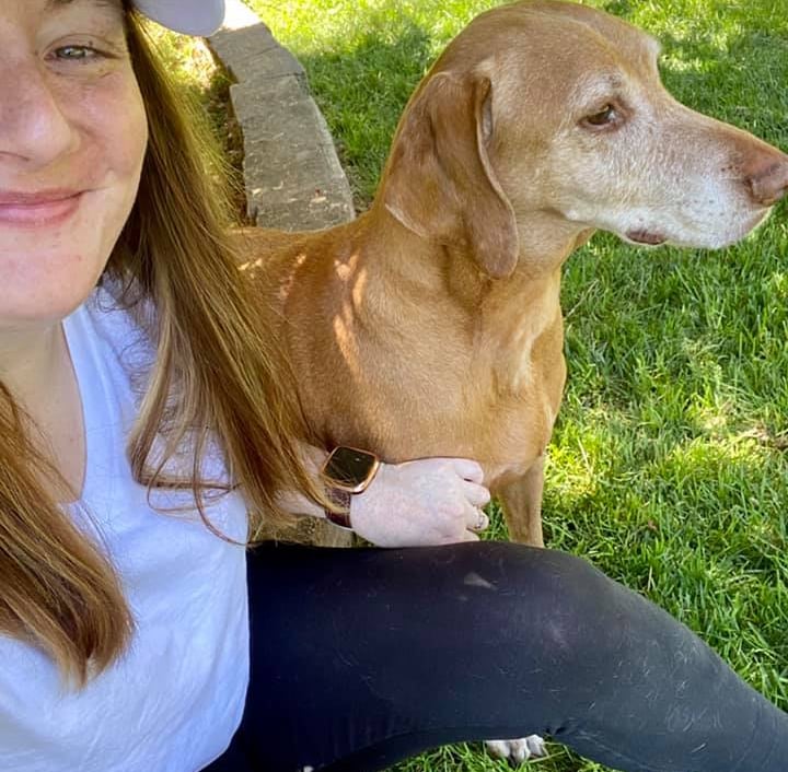 girl with a dog next to her