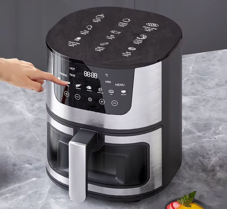Modern air fryer on a kitchen counter with freshly cooked healthy food