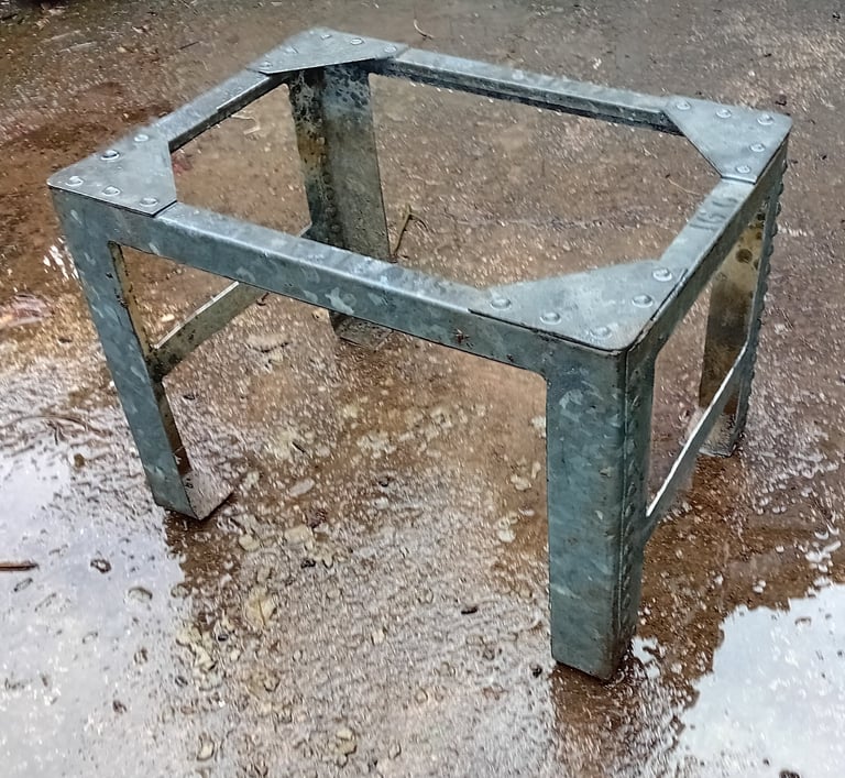 The sides and base of the tank have been cut away to leave 4 legs with cross bars and the top edges