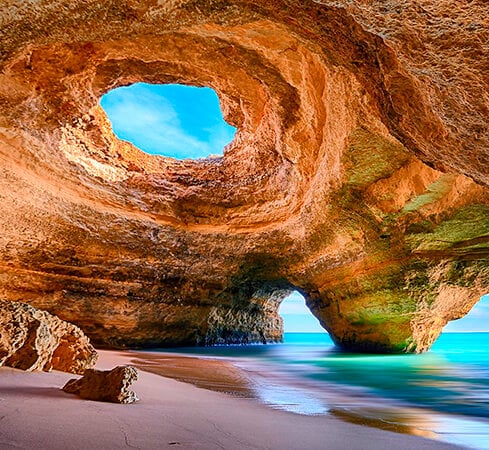 a cave in a cave with a view of the ocean