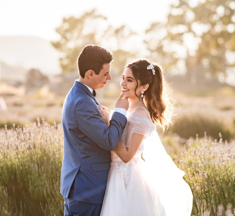 a bride and groom standing in a field