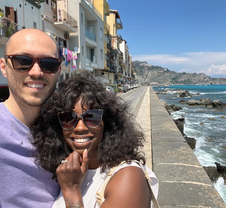 a man and woman taking a selfie with a camera