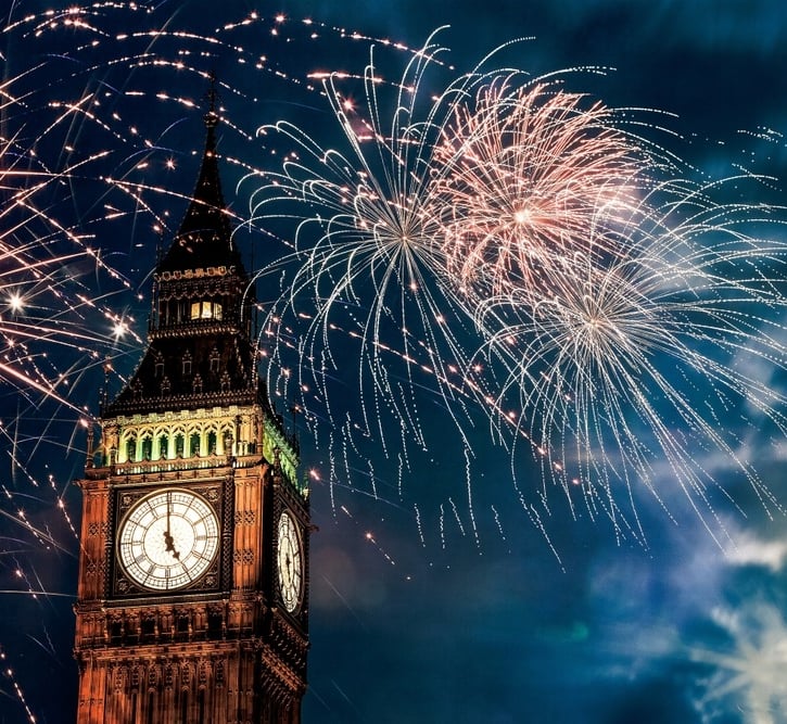 a clock tower with fireworks in the sky london