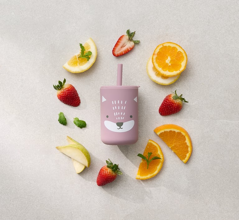 Product photography - a kids cup in the middle of fruit