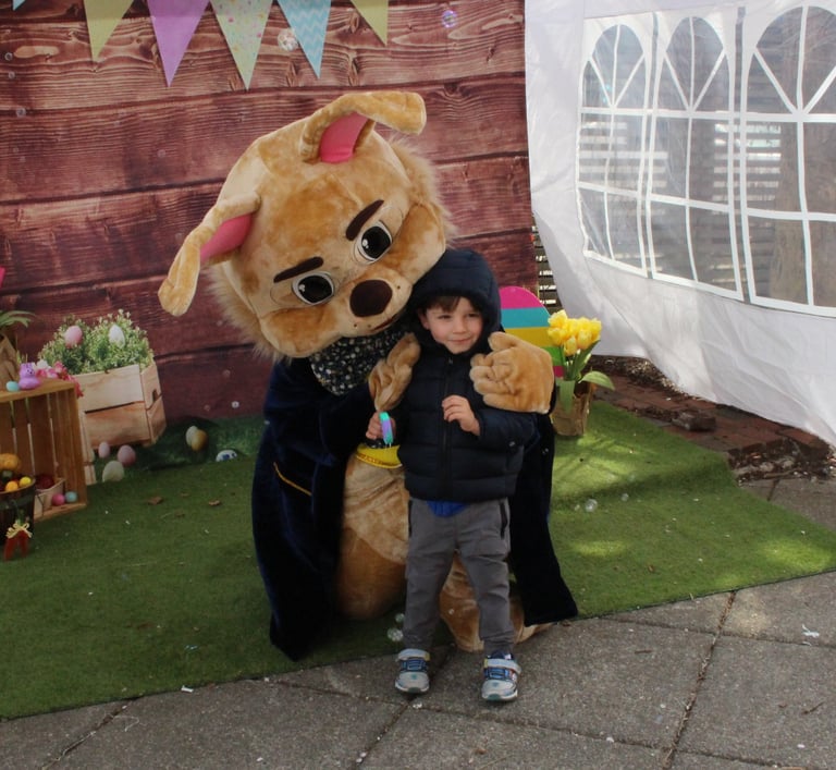 Easter Bunny shares a hug with a kid