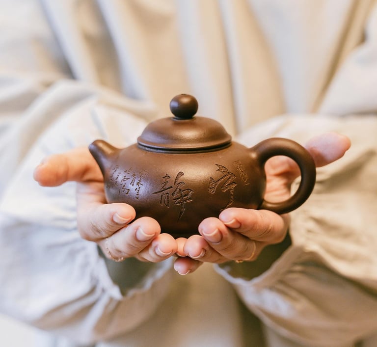 Holding a teapot in hands