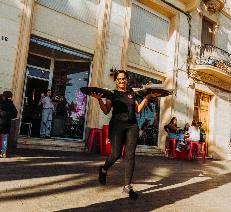 Waitress leaving Santa Lola Badalona with trays and good vibes