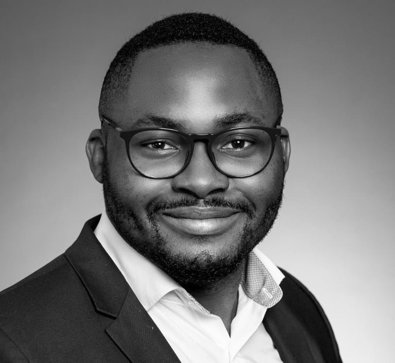 a man in a suit and glasses smiling