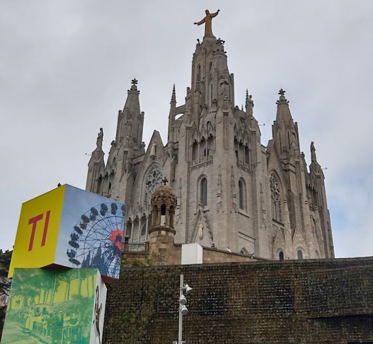 a large Tibidabo church building with a statue of a statue of a person on top of it