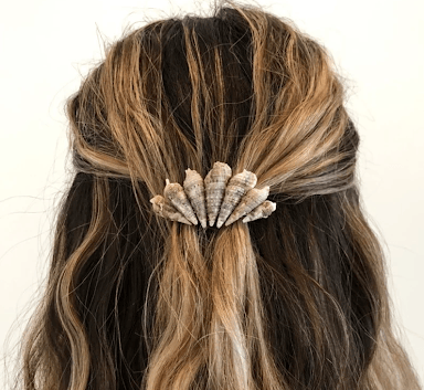 Hair clip made with shells, arranged to look like a larger "shell" shape.