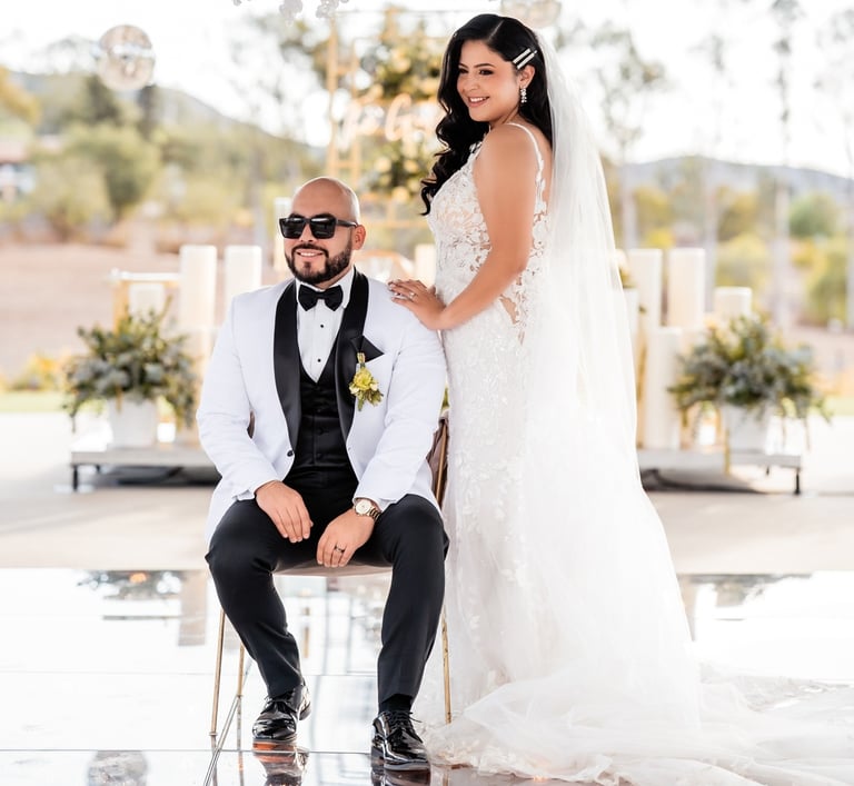 a bride and groom sitting on a chair in a wedding ceremony