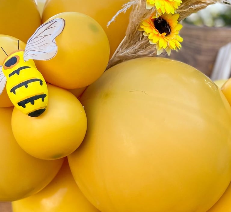 a bunch of balloons and balloons with bees photo backdrop event designer