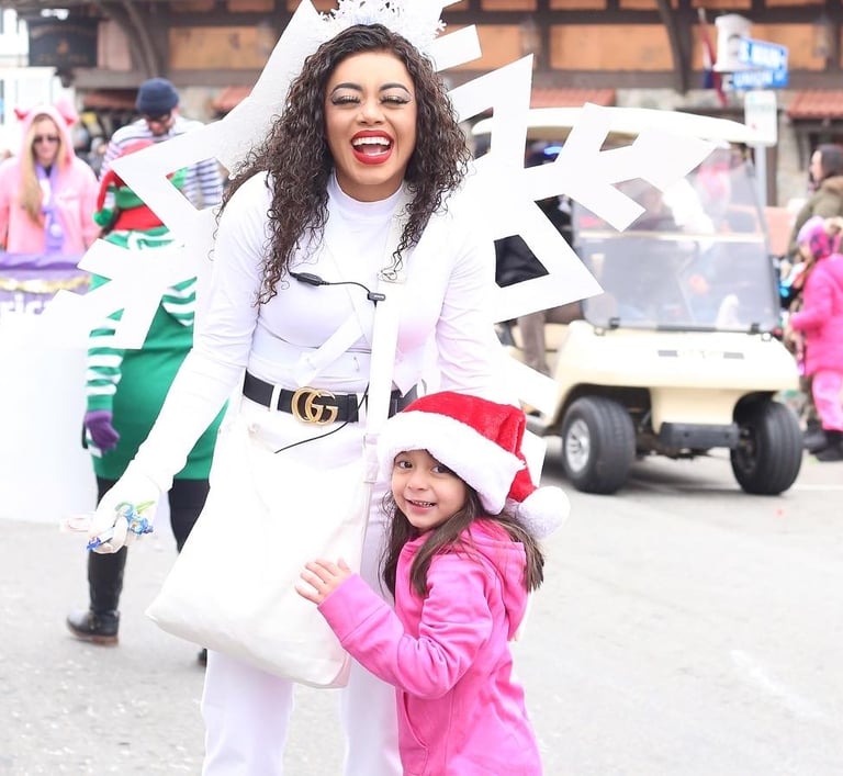 Snowflake skater poses with a kid for a photo