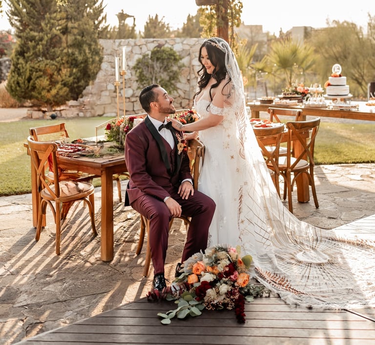 a bride and groom sitting on a chair in a wedding ceremony
