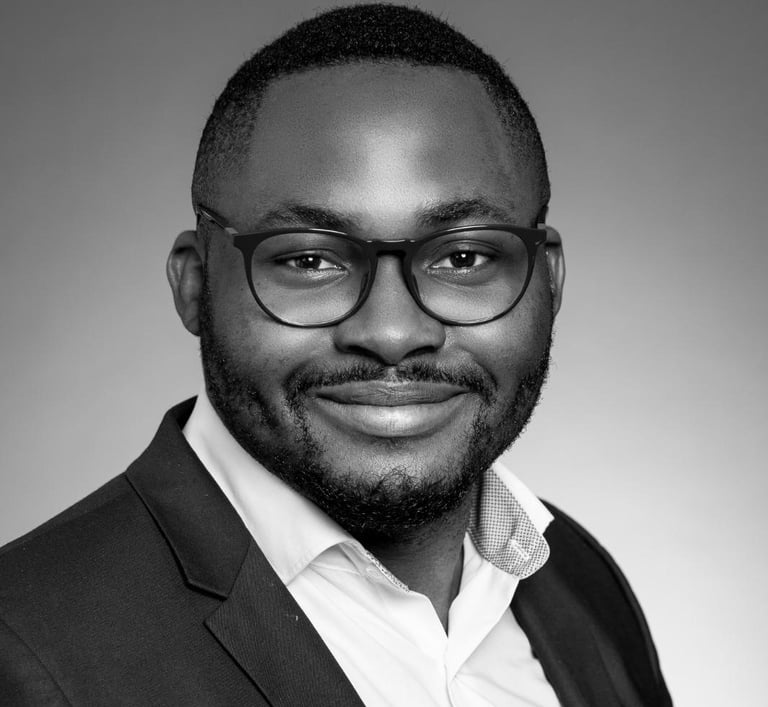 a man in a suit and glasses smiling