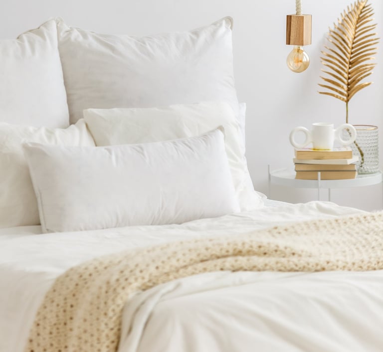 a bed with a white bed and a lamp