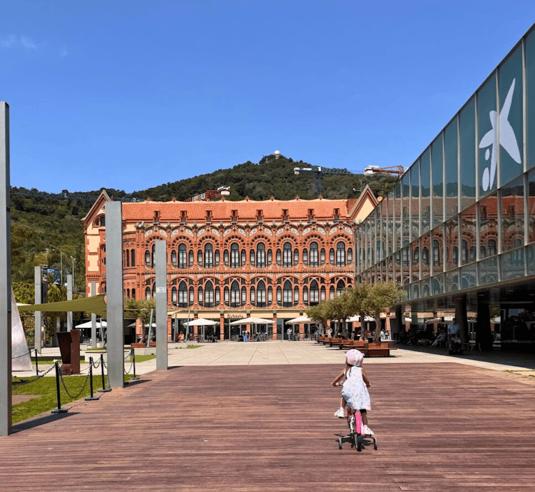 a little girl riding a scooter at cosmocaixa science museum terrace in barcelona