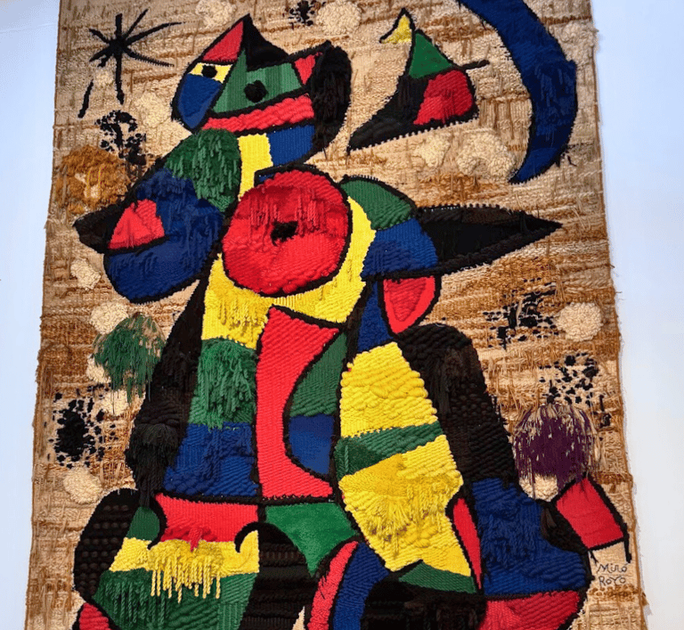 a colourful painting on a wall in the Joan Miro Museum