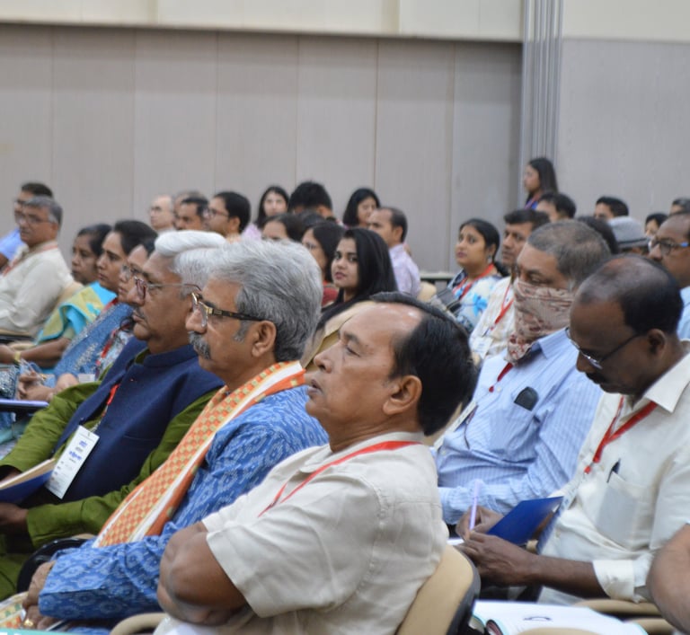 a group of people sitting in chairs in a room