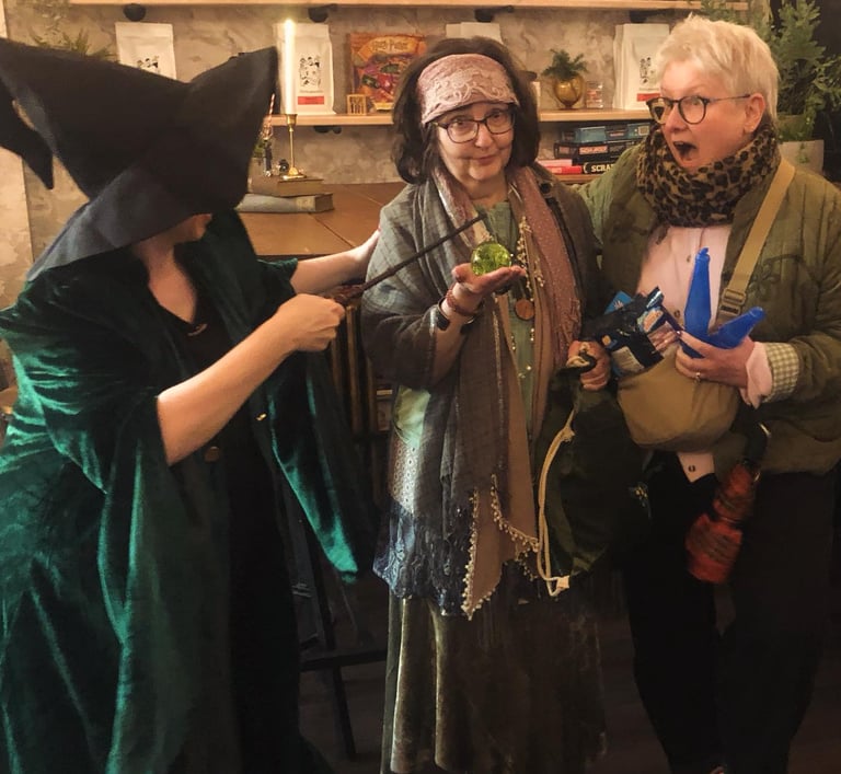 three women at a Harry Potter themed quiz. one looks shocked.