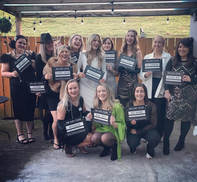 a group of girls at a1920s murder mystery party.