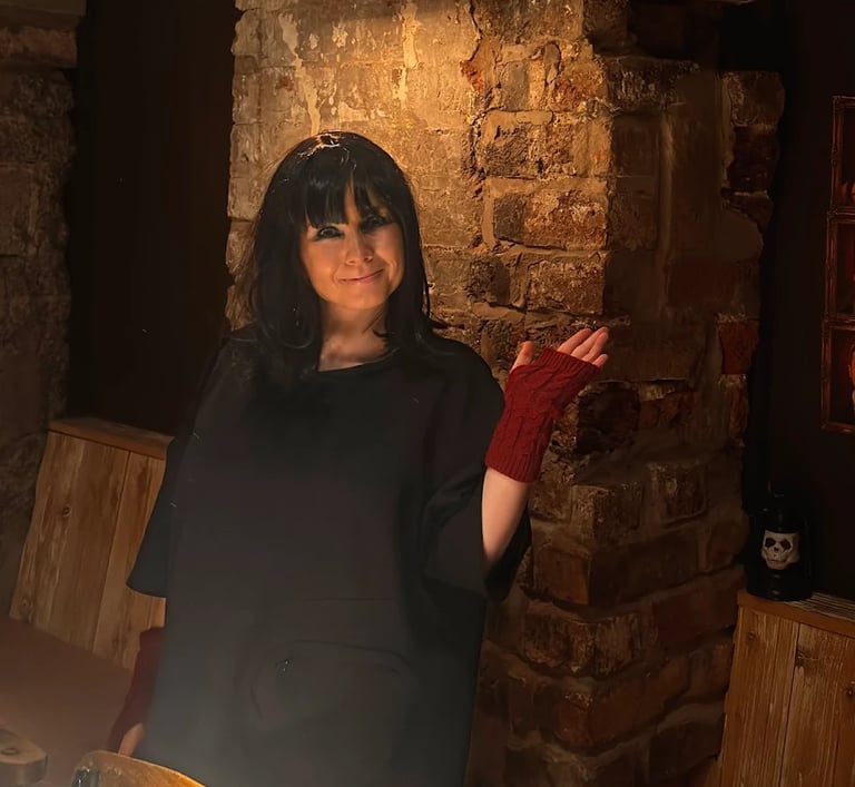 woman at Traitors event wearing a wig and red fingerless gloves.