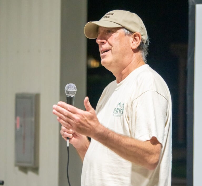 Man holding a microphone talking