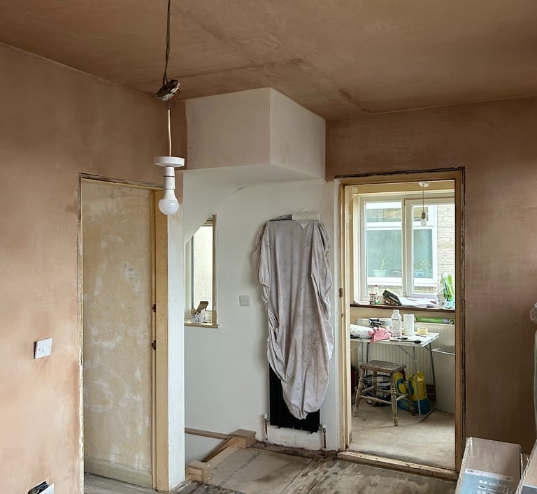 Stairs in, plastering done, new radiator under protection!