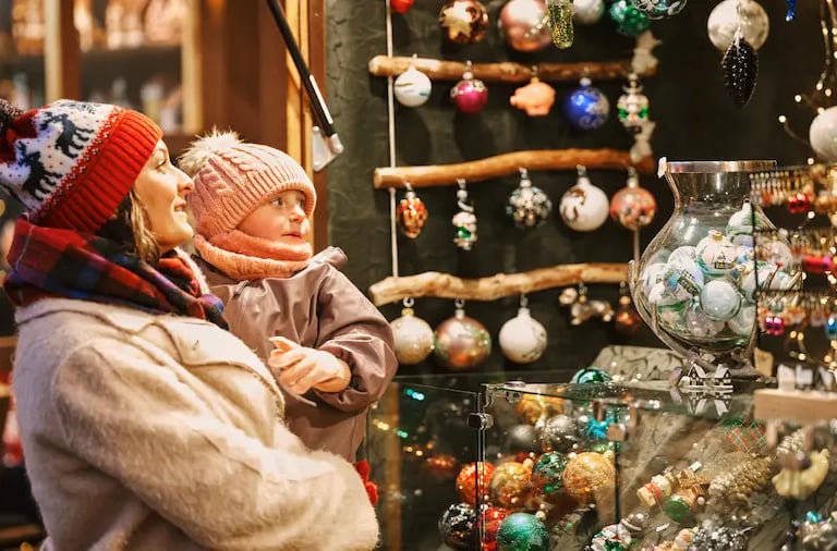 "Mother and child enjoying Christmas ornaments at Bolzano Christmas Market in South Tyrol