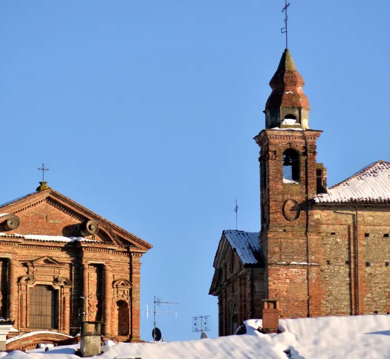 Historic center of La Morra Italy with cobbled streets and old houses with snow