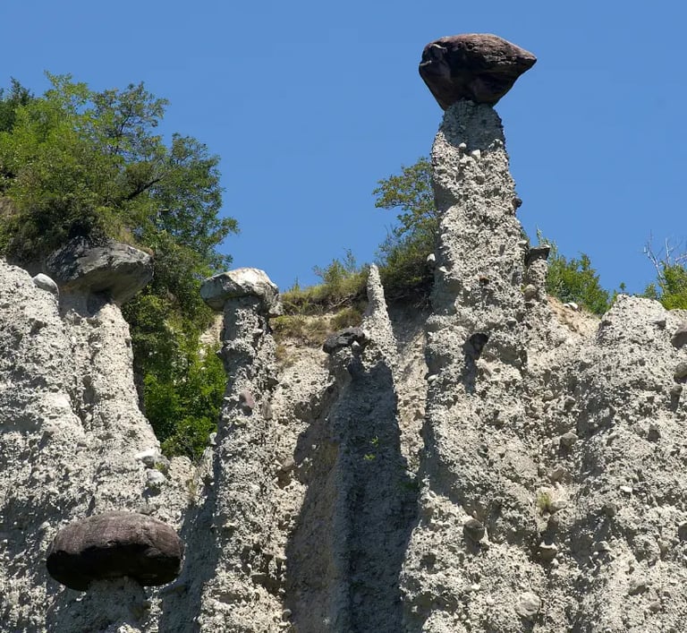 Earth Pyramids of Zone, tall stone spires capped with boulders near Lake Iseo