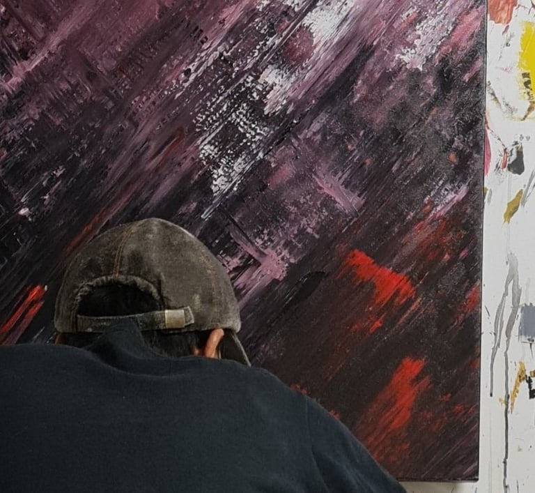 a man is painting a large painting on a canvas