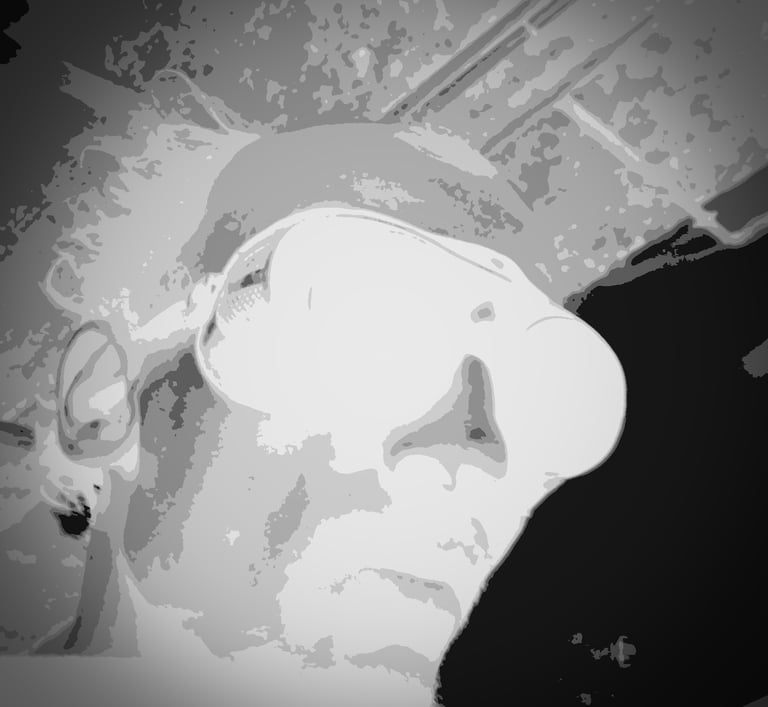 a man with a hat and sunglasses on a black and white photo