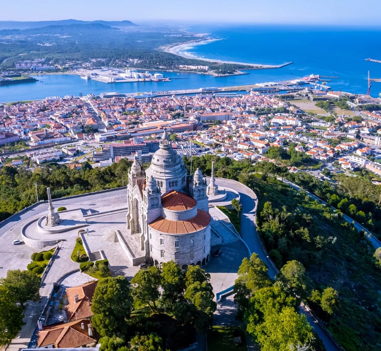 a large church with a steeple and a view of the ocean