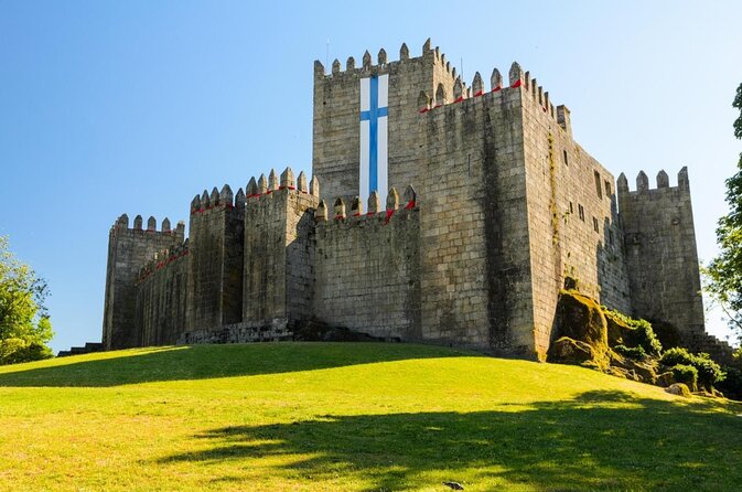 a castle like structure with a cross on the top of it