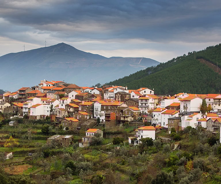 a mountaintop with a view of a village