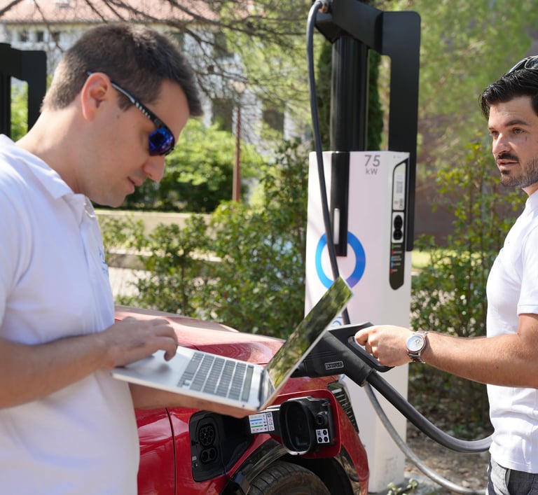 Employés devant une station de recharge électrique