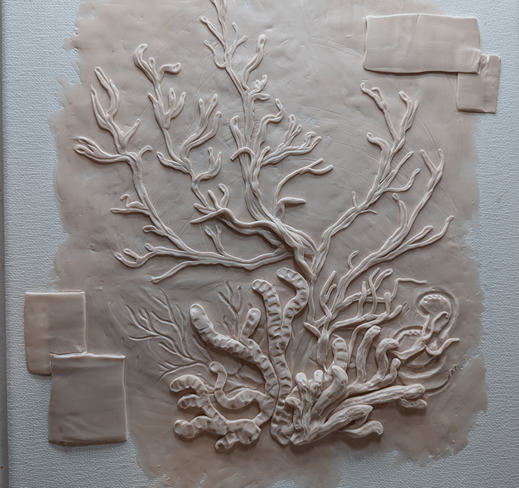 Polymer Clay relief sculpture on stretched canvas of a coral reef underway.