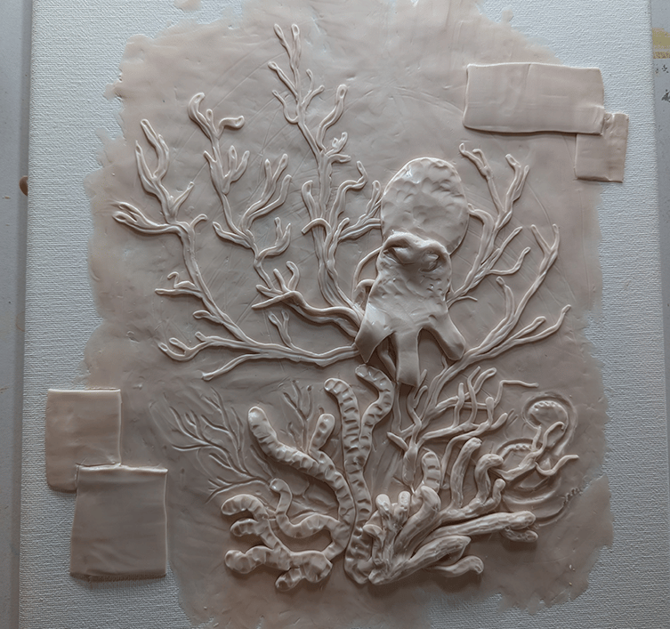 Layering elements and adding detail to a polymer clay relief sculpture on stretched canvas.