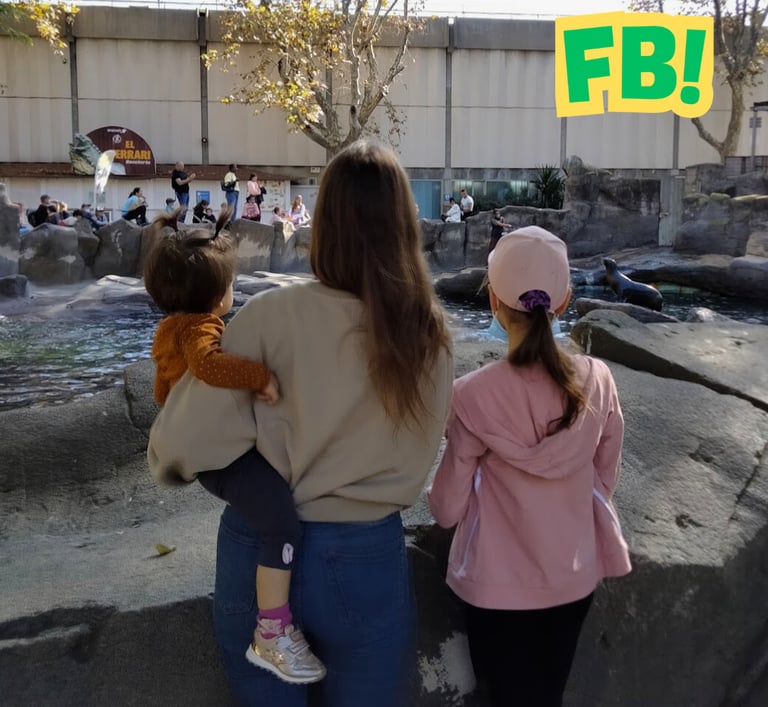 a woman and two children at the zoo
