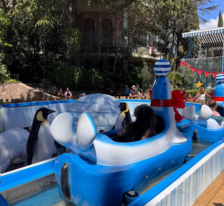 a group of penguins in a boat shaped like a boat at Tibidabo Barcelona