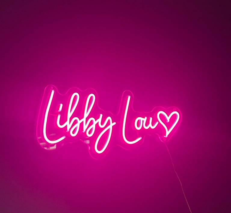 a custom neone sign in pink '