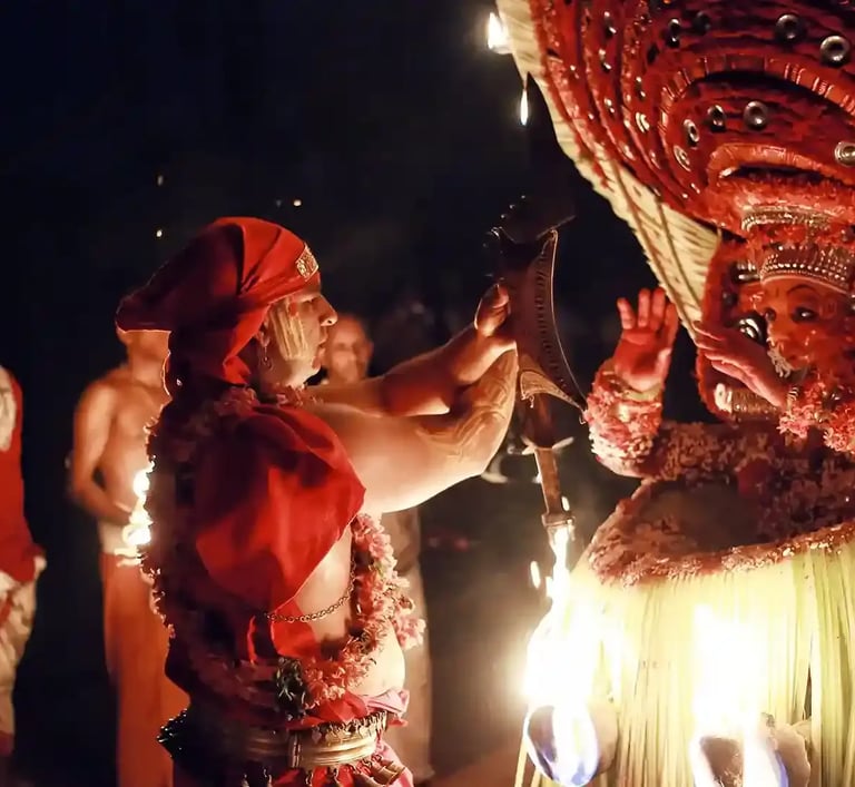 Person performing Theyyam ritual in Kerala, adorned in traditional attire.